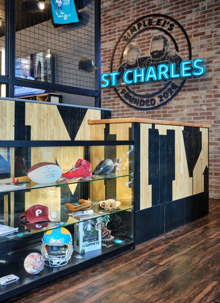 Entry memorabilia case and neon sign at Simple EJ's